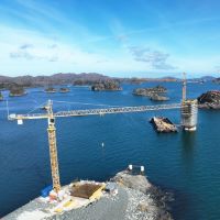 Cranes tower over Norwegian coastal bridge logo 